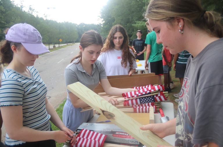 High school students place flags, signs, in honor of 9/11 victims